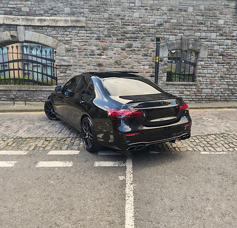Front view of black Mercedes-AMG E63 S supercar hire vehicle