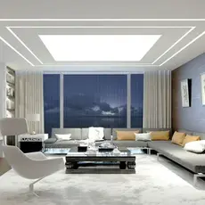 A modern living room featuring white furniture and a large window that allows natural light to fill the space