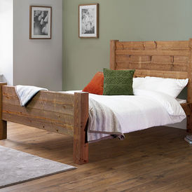 Rustic reclaimed wood bed frame with a high solid headboard