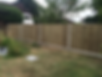 Timber fencing panels with concrete posts installed along a garden border