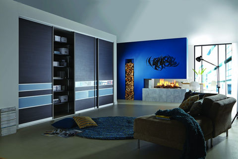 Deep blue sliding wardrobes in a bedroom with vibrant blue walls