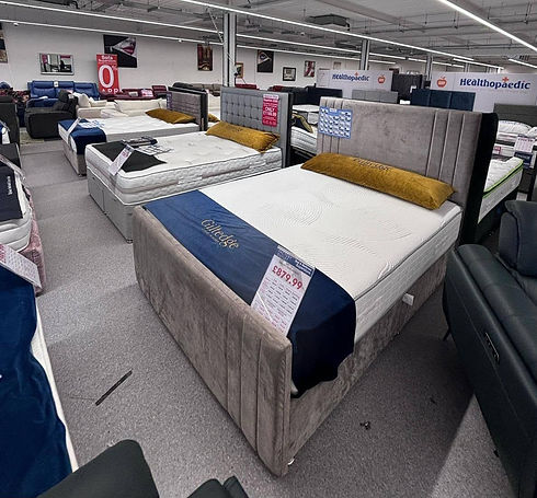 A spacious room filled with multiple beds and mattresses arranged neatly for accommodation