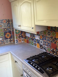Kitchen worktop featuring vibrant colourful patterned Moroccan style mosaic splashback tiles