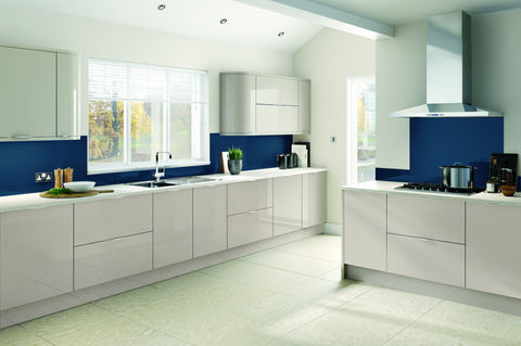 Sleek white kitchen with vibrant blue backsplashes