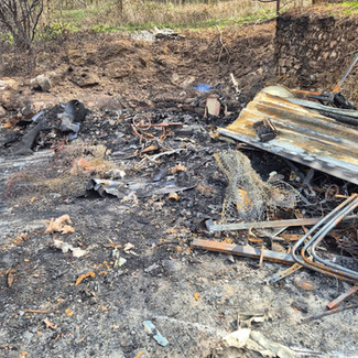 Burnt timber and scrap after site clearance