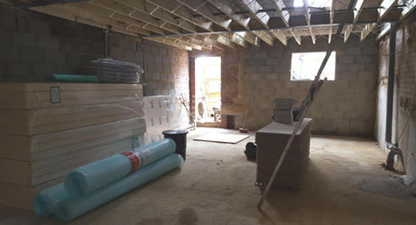 Spacious, unfinished basement with exposed beams