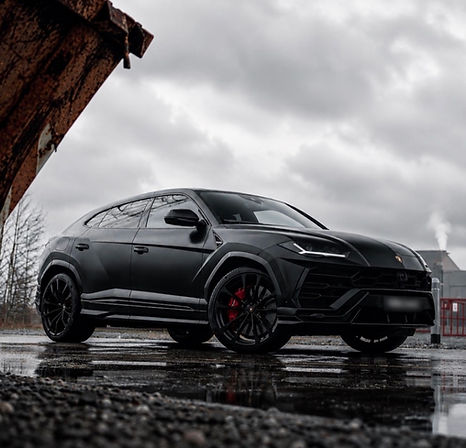 Side view of black Lamborghini Urus super-SUV hire vehicle