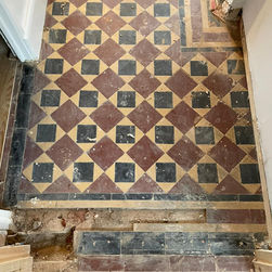 Dirty geometric entrance tiles before restoration