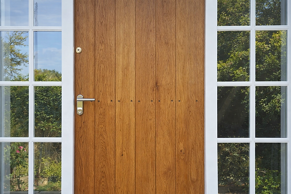 A wooden door featuring white trim and glass windows, showcasing a classic design and inviting appearance