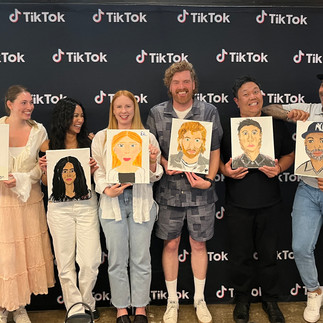 eam-building tote bag painting workshop hosted at TikTok Canada, with employees engaging in a creative group activity