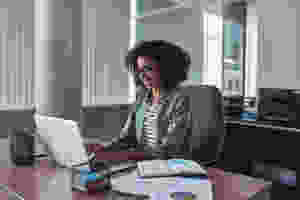 small business owner on computer completing her content calendar