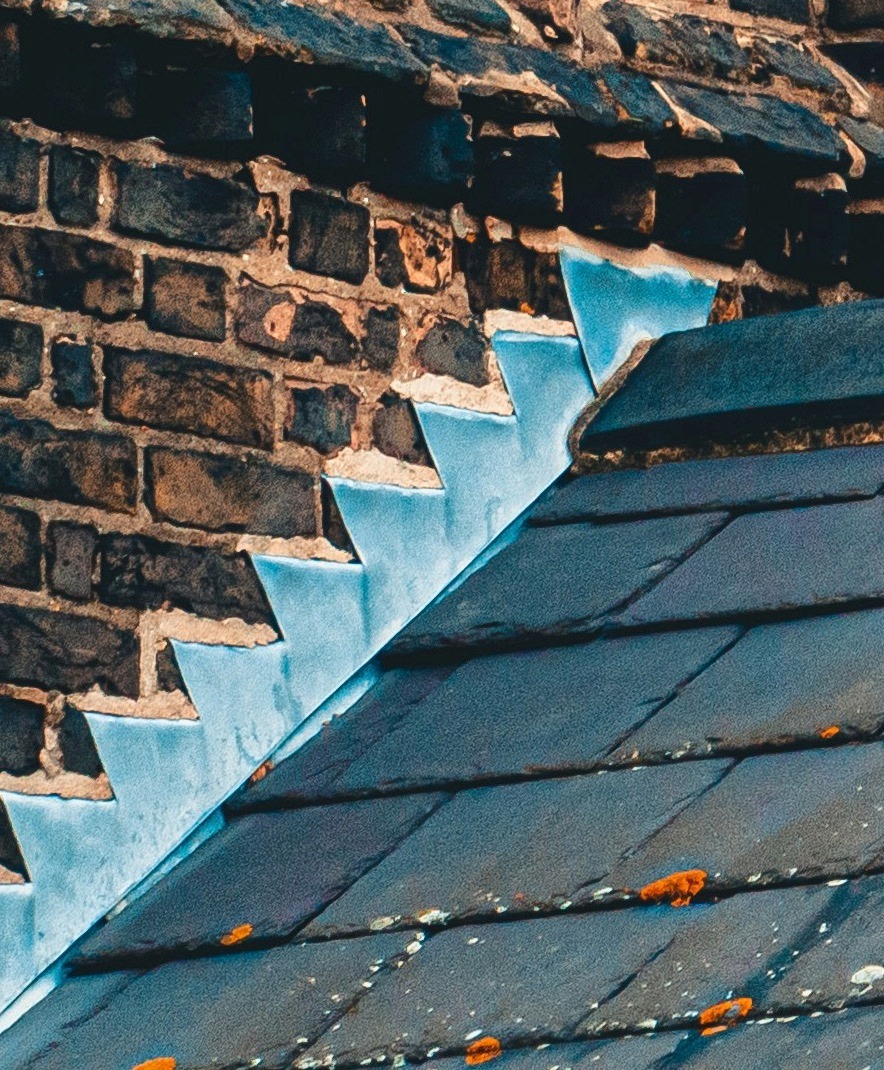 Roof flashing defect causing water penetration around chimney
