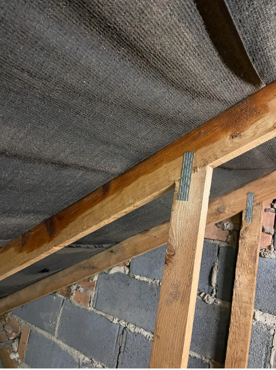 Damp or water stains on the underside of the roof covering or on timbers