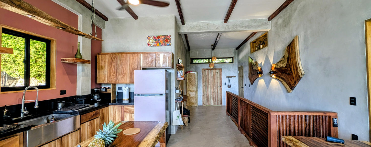 Cozy dining corner with built-in seating in Belize jungle villa