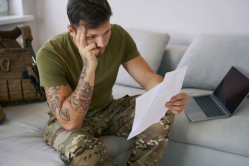 stressed-out-military-man-reading-document-and-rub-2024-10-18-09-30-59-utc.jpg