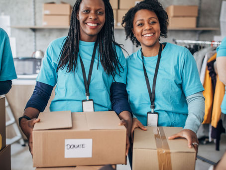 People holding donation boxes