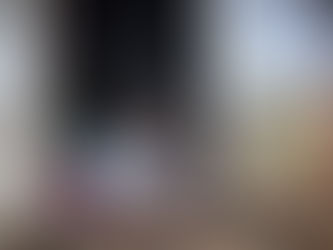 Child eating at the doorstep of a shanty.