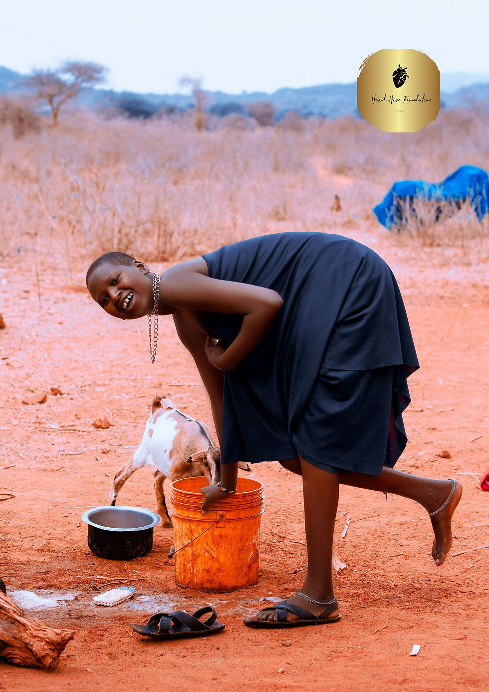 Smiling Woman Fetching Water in African Landscape.