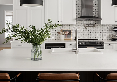 Two-tone kitchen renovation in Beaconsfield featuring glass display cabinets, quartz countertops, marble mosaic backsplash, and structural beam installation.
