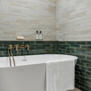Freestanding soaker tub with wall-mounted tub filler
