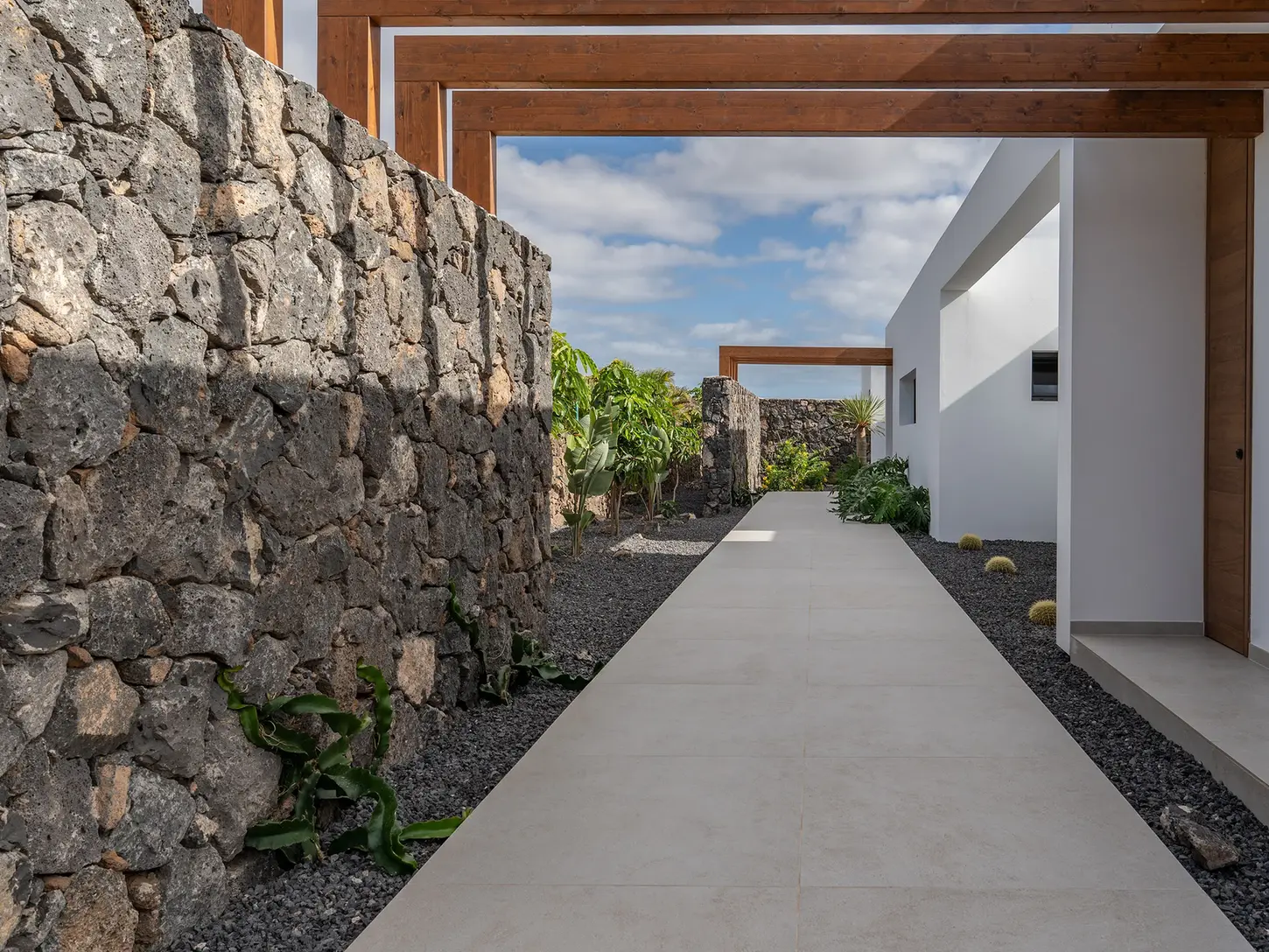 External path with stone wall and access to the villa