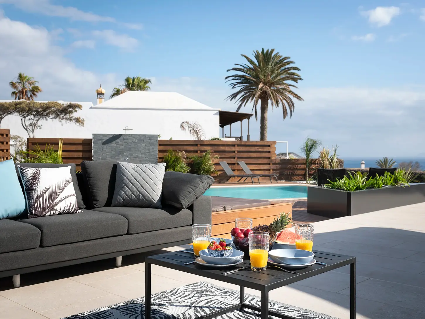Outdoor lounge area with outdoor furniture and pool view