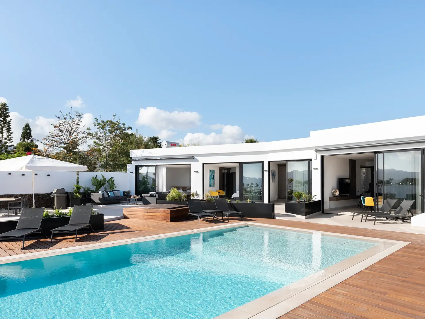 View of the villa with swimming pool and outdoor spaces during the day