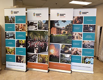 4 banner stands facing forward in a row