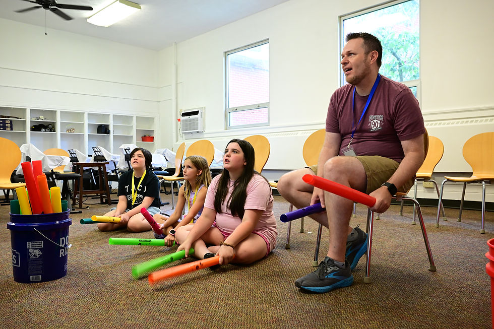 Instructor Matt Leedy brings the fun and energy as students make music with boomwhackers.