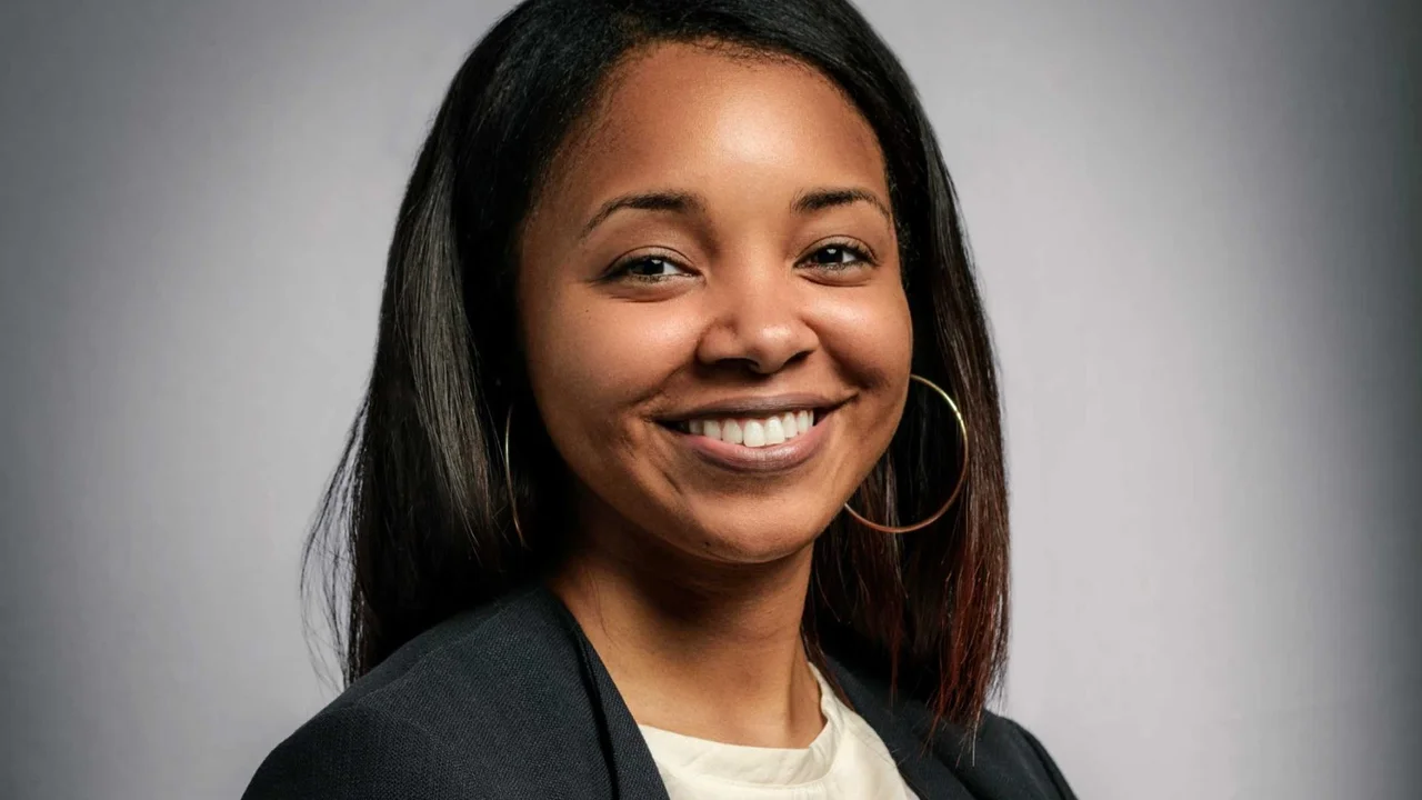 Minority businesswoman Sheena Allen smiling portrait on gray background.