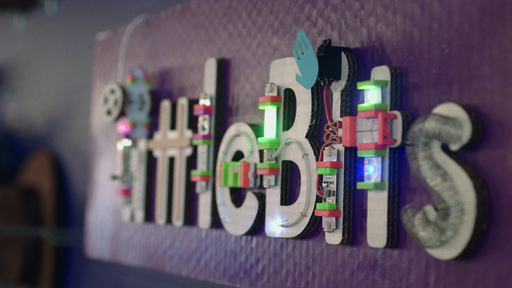 littleBits textured 3d logo on wall with white letters of word littleBits adorned with littleBits product modules.