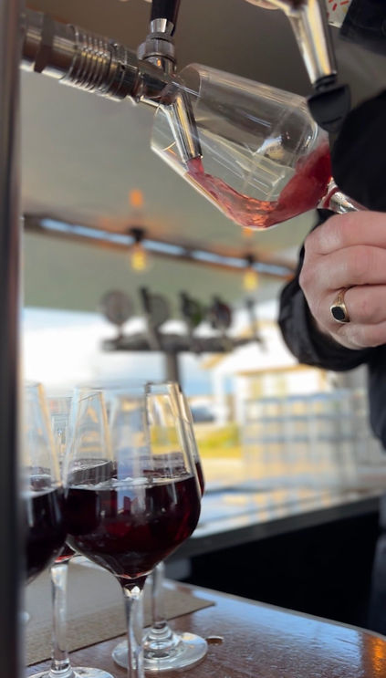 Pinot noir being poured out the tap at a corporate function as part of unlimited beverage package