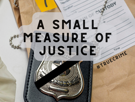 A photo of police paperwork and a police officer's badge with a black mourning band.