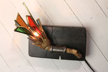 Bamboo, reclaimed wood and steel meld together into sprouting blossoms of deconstructed stained glass, filling the atmosphere with a soft light littered with sharp refractions of color. Touch Sensitive.