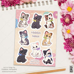 ein Stickersheet mit 8 Katzen in unterschiedlichen Farben. Am Rand des Bildes sind pinke und rosa farbende Blumen