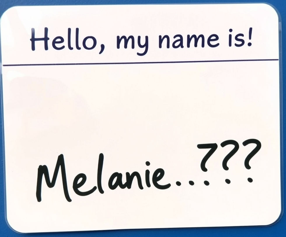 Eye-level view of a vintage typewriter with a sheet of paper showing the name Melanie Celeste Dawson