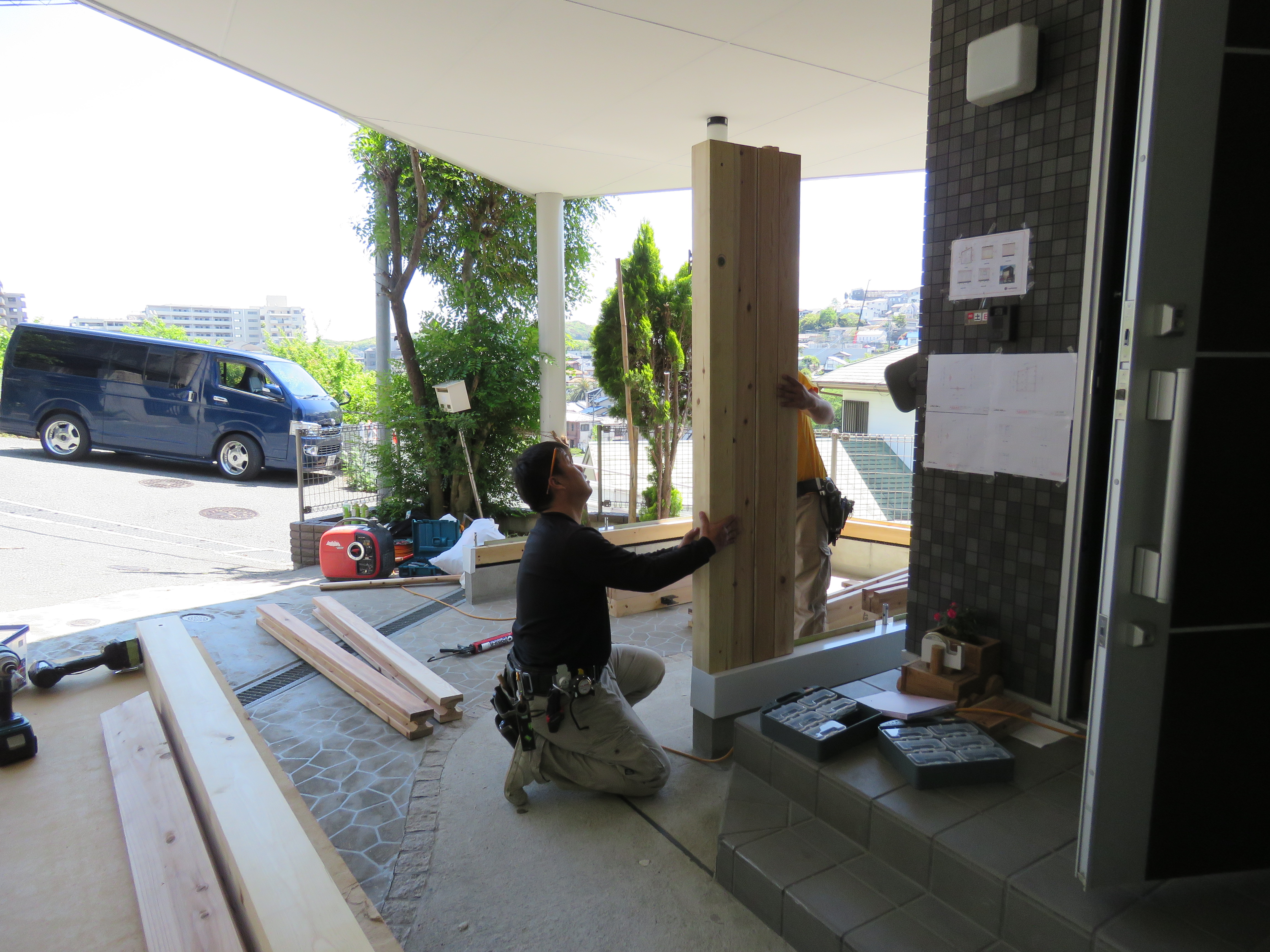 工務店の大工が木製ガレージの柱を建てます。