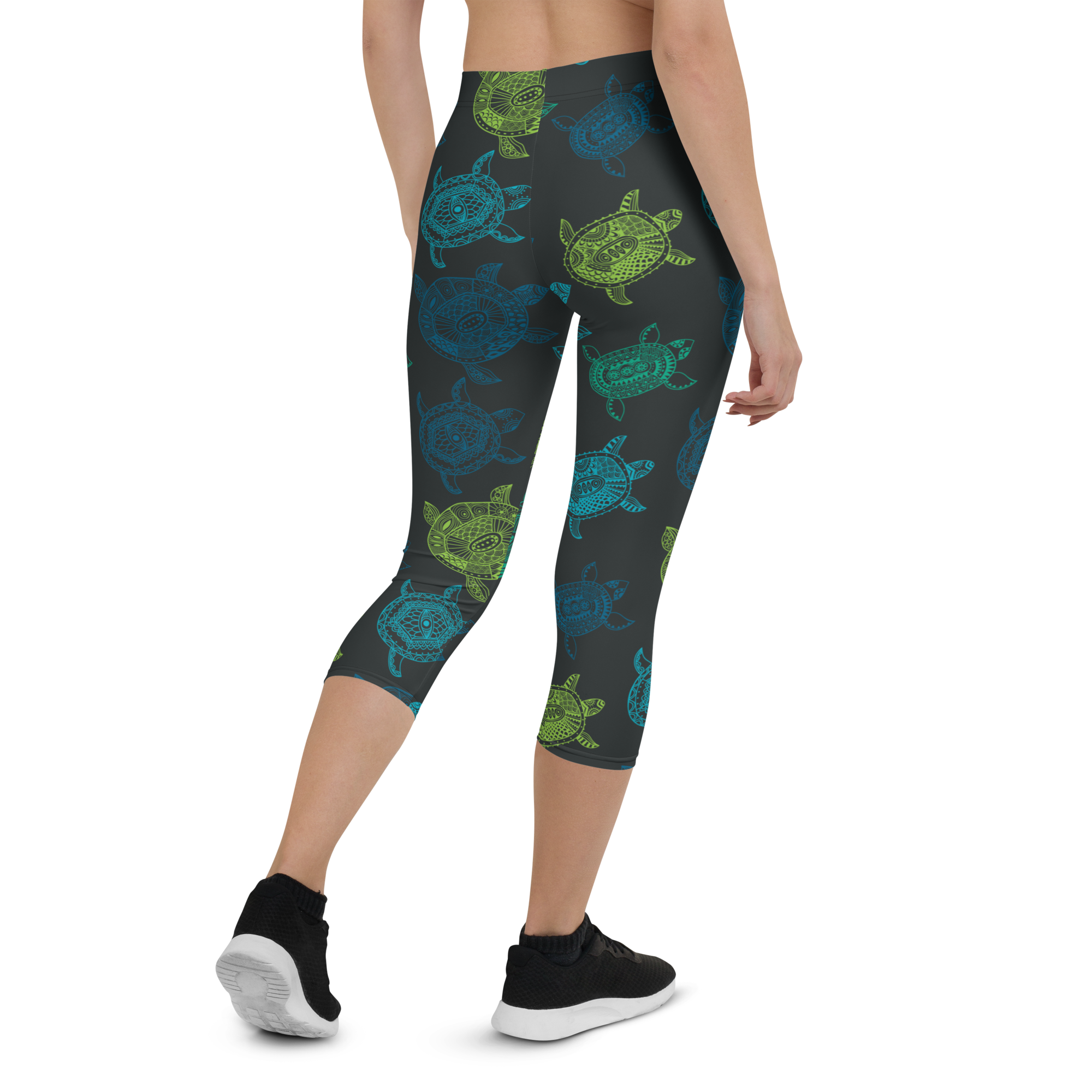 Woman wearing Women's CoastFlex Turtle Bay Capri Leggings; turtles print design. FFG