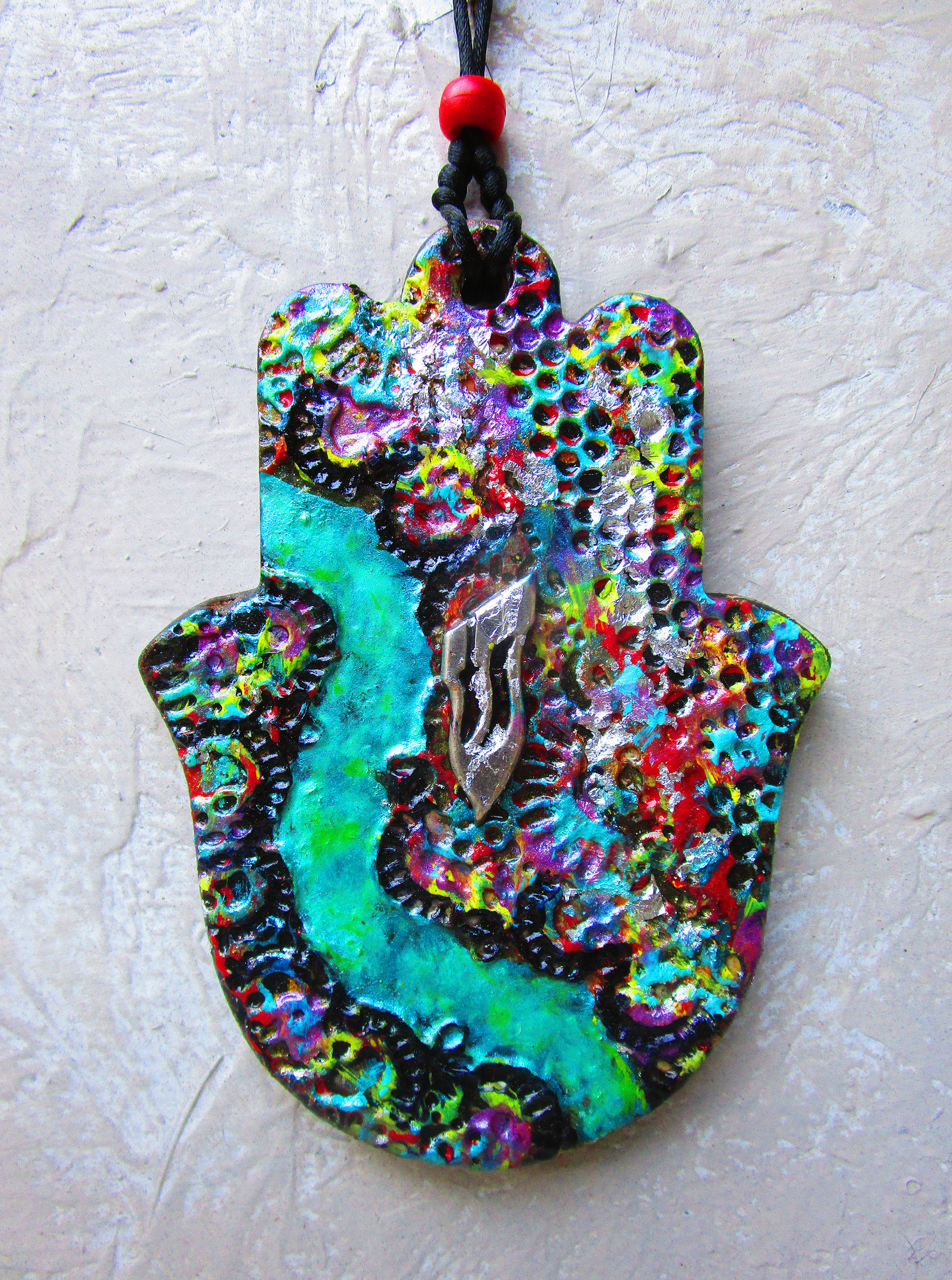 Handmade green path ceramic hamsa wall hanging.