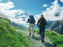Two hikers climbing a mountain.