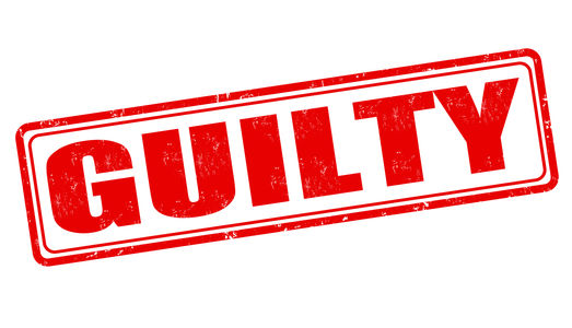 Red stamped GUILTY in bold distressed letters on a white background, tilted diagonally like an official verdict stamp.