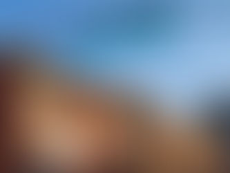 Street sign "St Marks Pl" above red brick buildings with fire escapes under a clear blue sky.