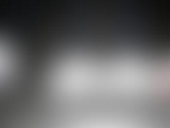 Four white spheres on strings, two with "PERSEVERANCE" and "SUCCESS" text. Marble texture, dark background. Suggests motion and focus.