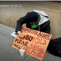 man on the sidewalk holding a sign