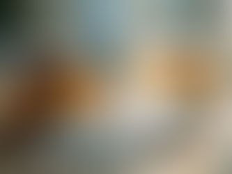 Spilled pill bottle with white pills on wooden table, beside a glass of amber liquid. 