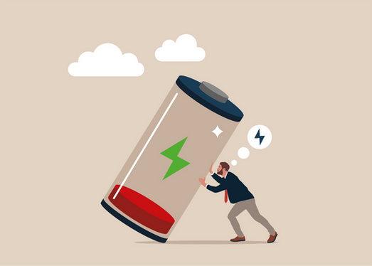 Man pushing a giant low battery icon on a beige background, with clouds and a lightning thought bubble showing fatigue and urgency.