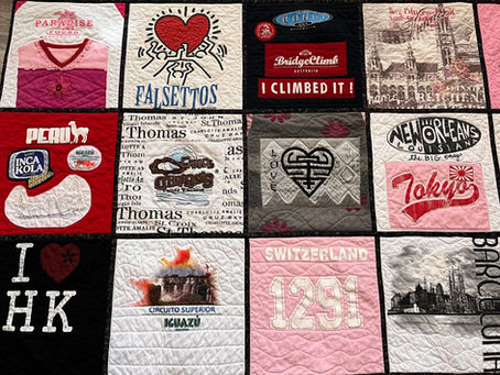 a quilt made of travel T shirts