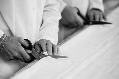 Fabrics being cut by hand in our atelier.