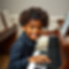 6 year old piano student at the piano smiling but be sure to obscure the face and make the