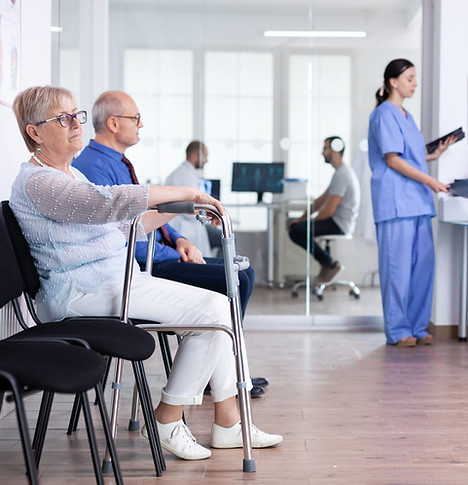 senior-woman-with-walking-frame-hospital-waiting-room-rehabilitation-treatment-2048x1365.j